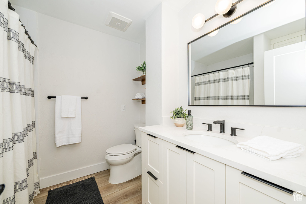 Bathroom with vanity and wood finished floors