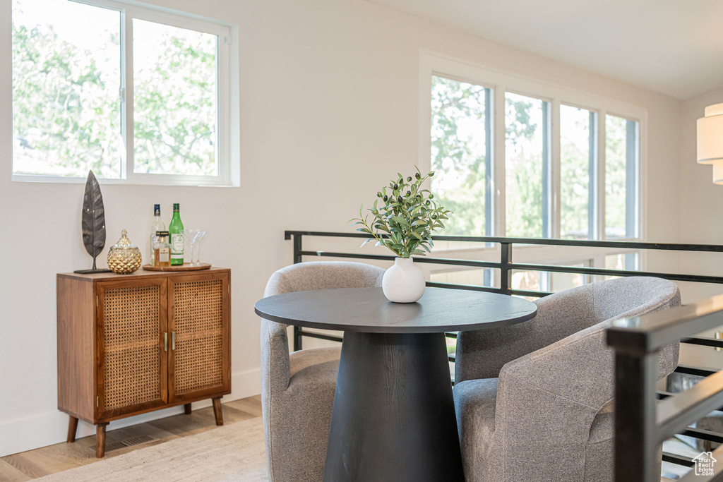 Dining space with healthy amount of natural light and wood finished floors