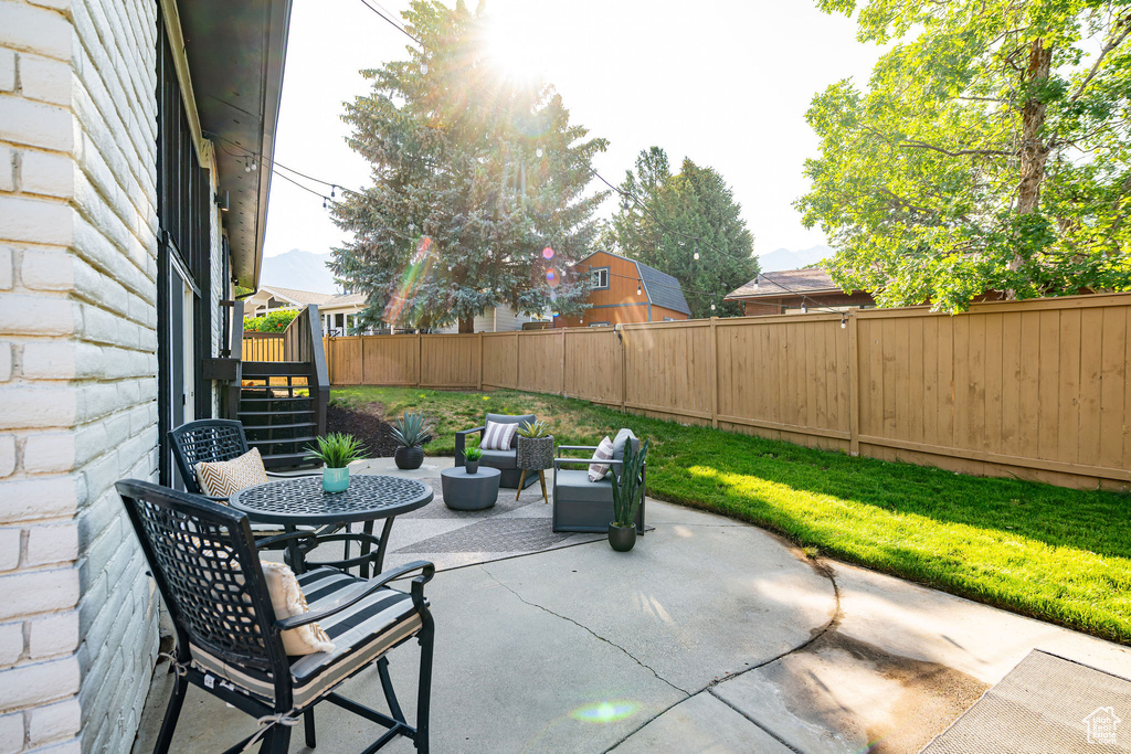 Fenced backyard featuring a patio area and stairs