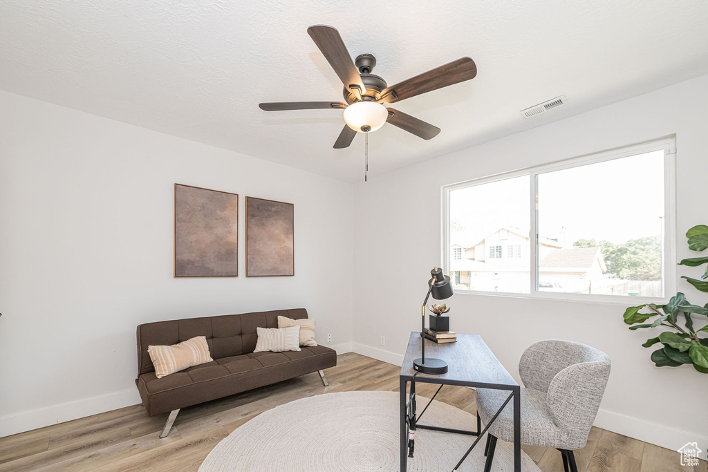 Home office featuring ceiling fan and light wood-style flooring