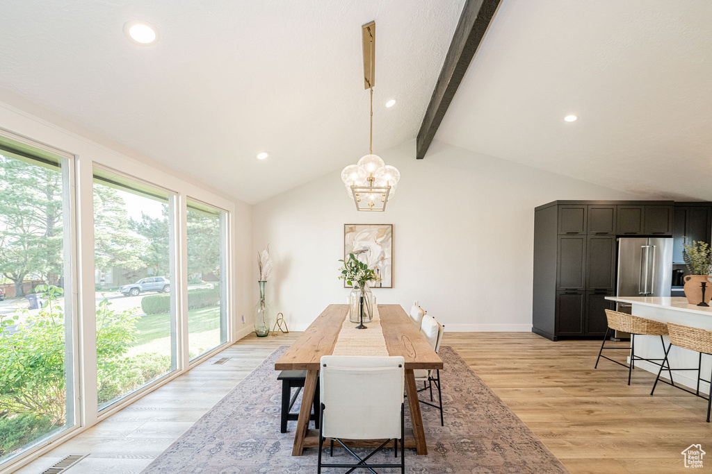 Dining room with plenty of natural light, light wood finished floors, and recessed lighting