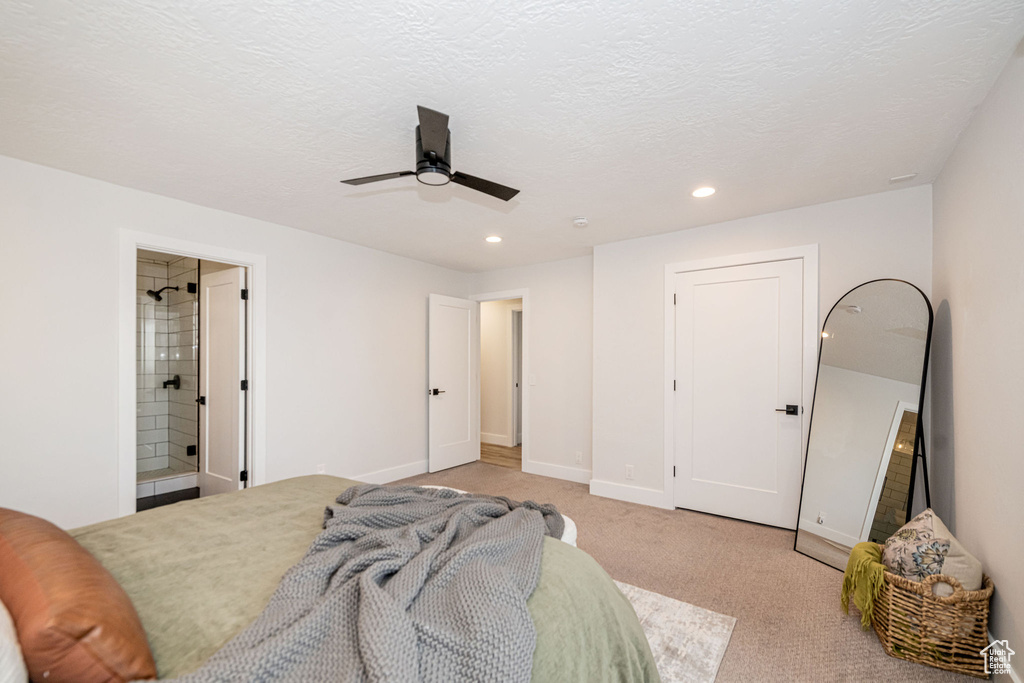 Bedroom featuring recessed lighting, light colored carpet, ceiling fan, ensuite bath, and a textured ceiling