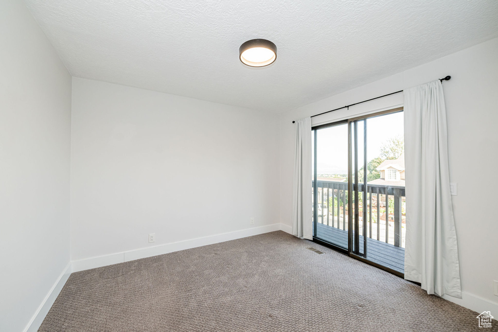 Unfurnished room featuring carpet flooring