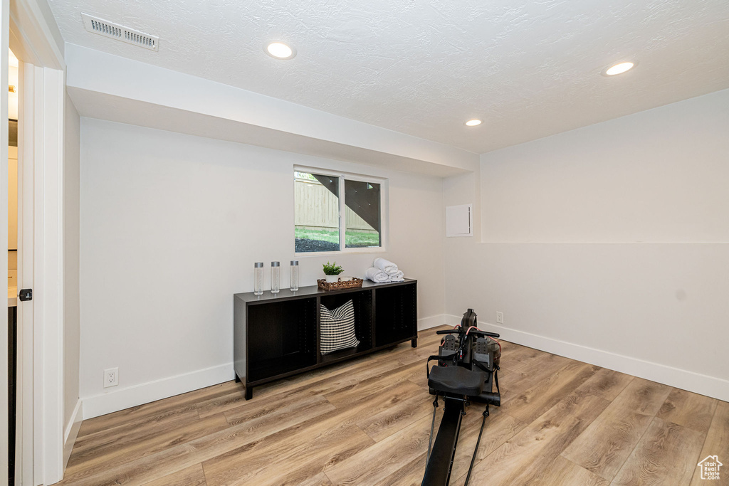 Interior space with light wood-type flooring and recessed lighting
