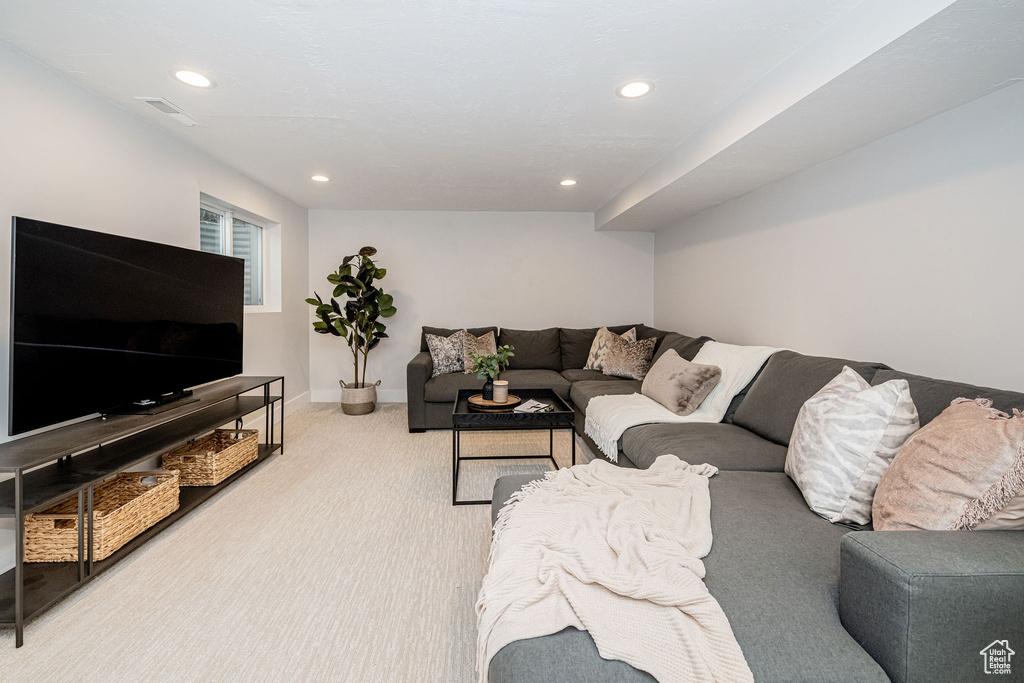 Living room with carpet flooring and recessed lighting