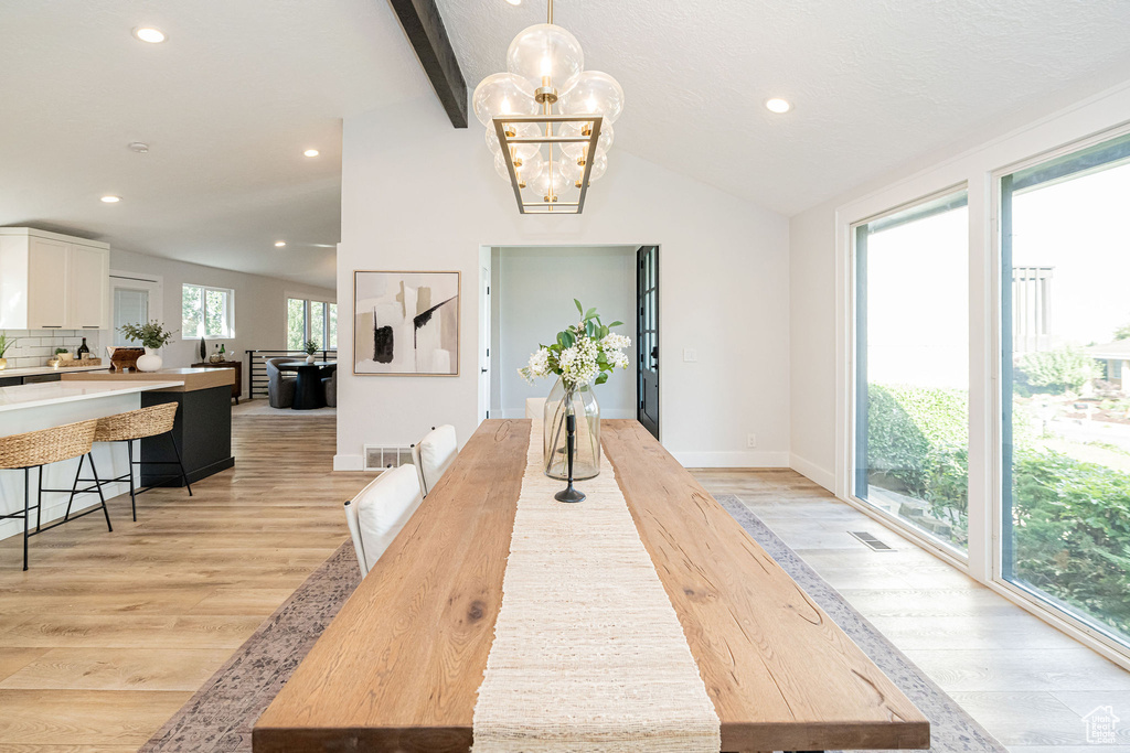 Dining room with light wood-style floors, recessed lighting, and a chandelier