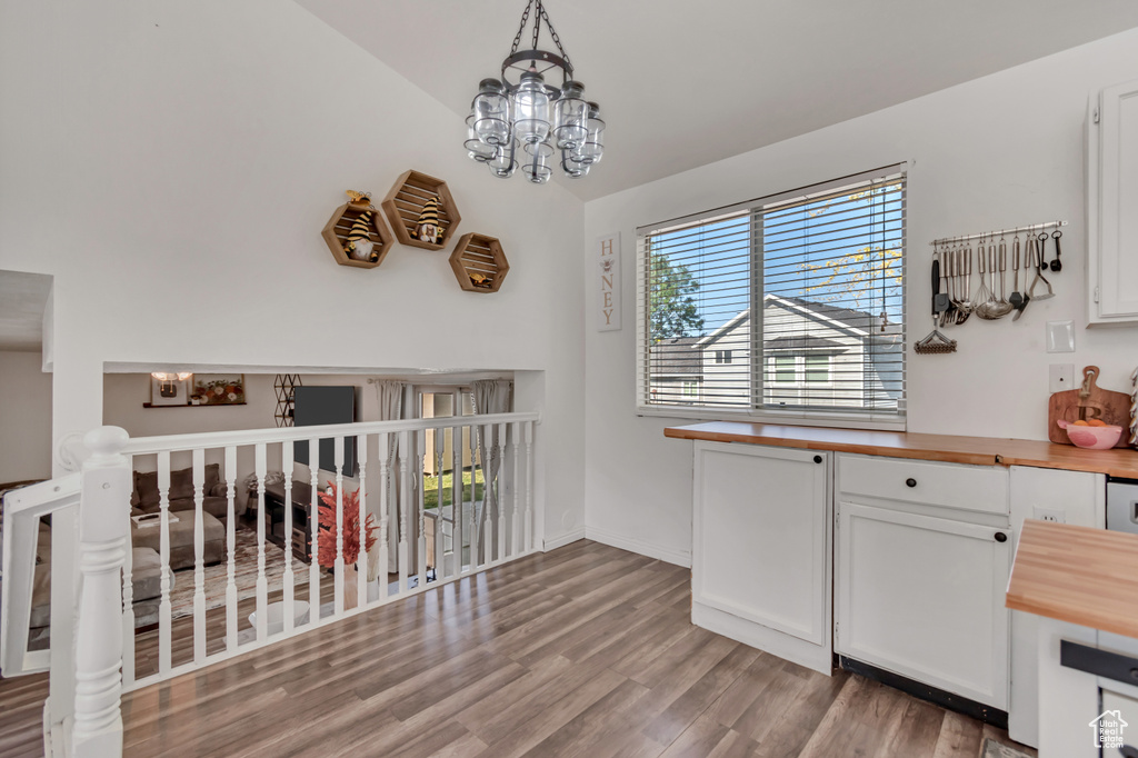 Dining space with wood finished floors and lofted ceiling