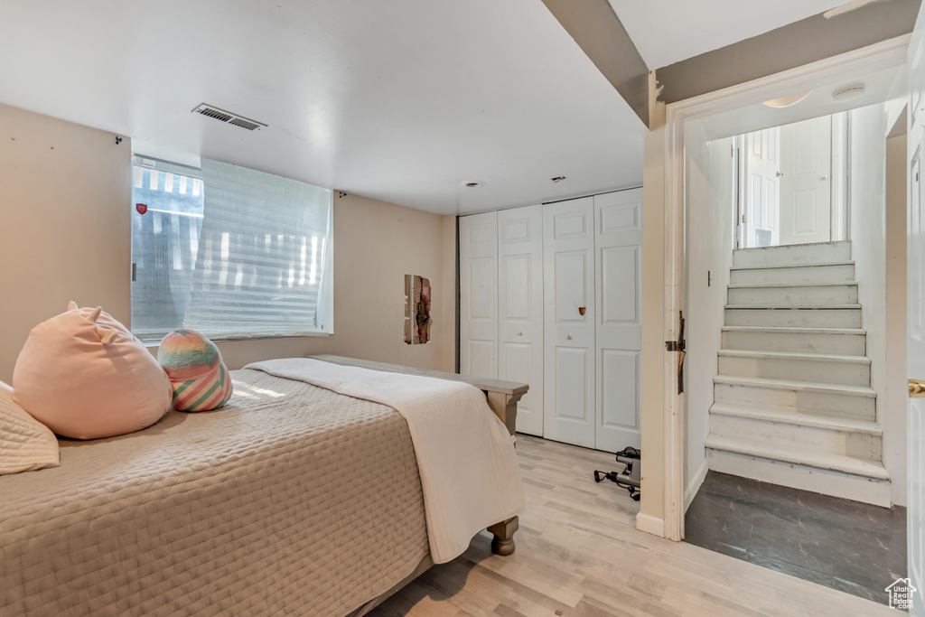 Bedroom with light wood-style floors and a closet