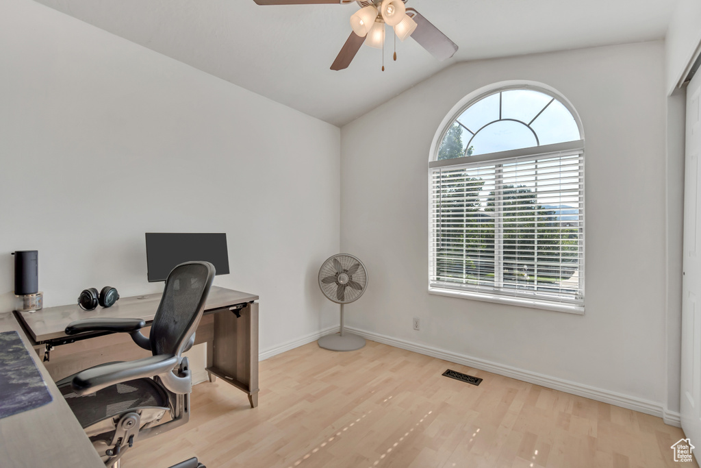 Home office with wood finished floors, a ceiling fan, and lofted ceiling