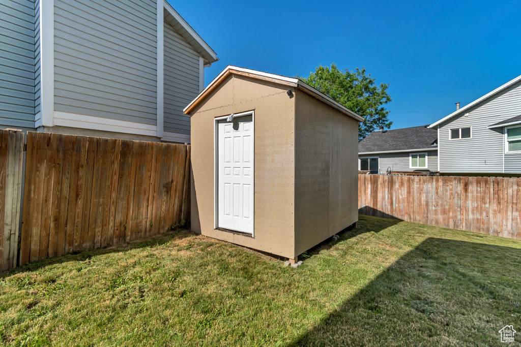 View of shed with a fenced backyard