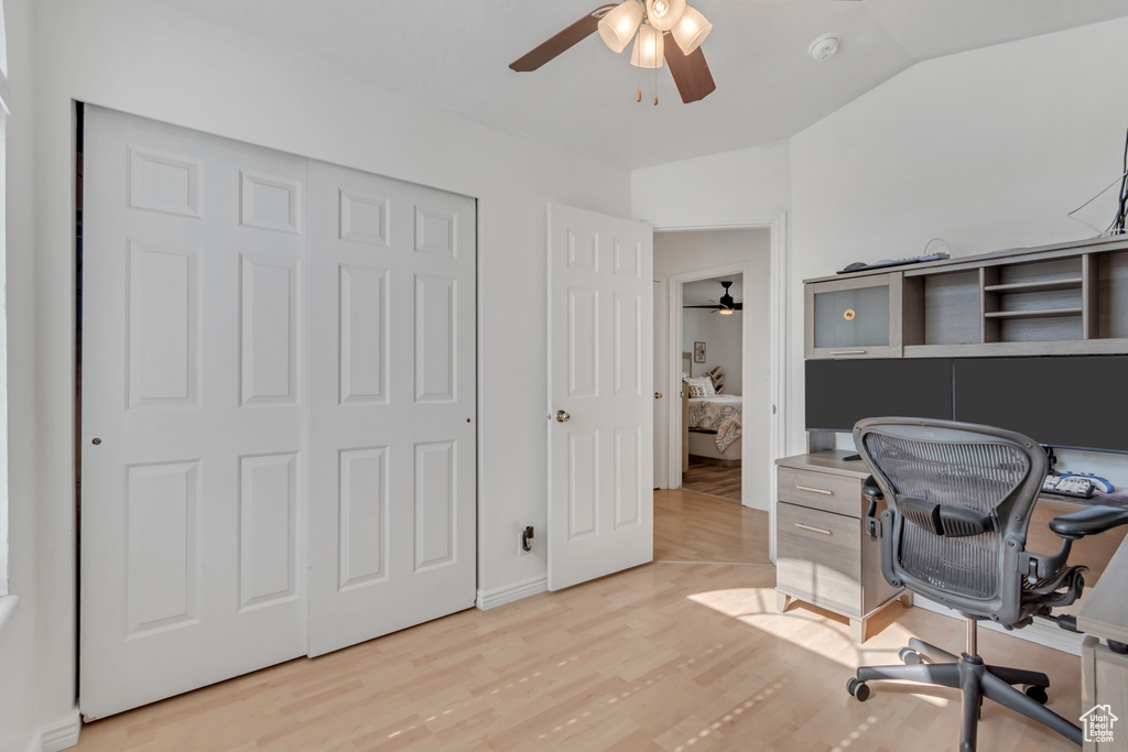 Office with a ceiling fan, light wood finished floors, and lofted ceiling