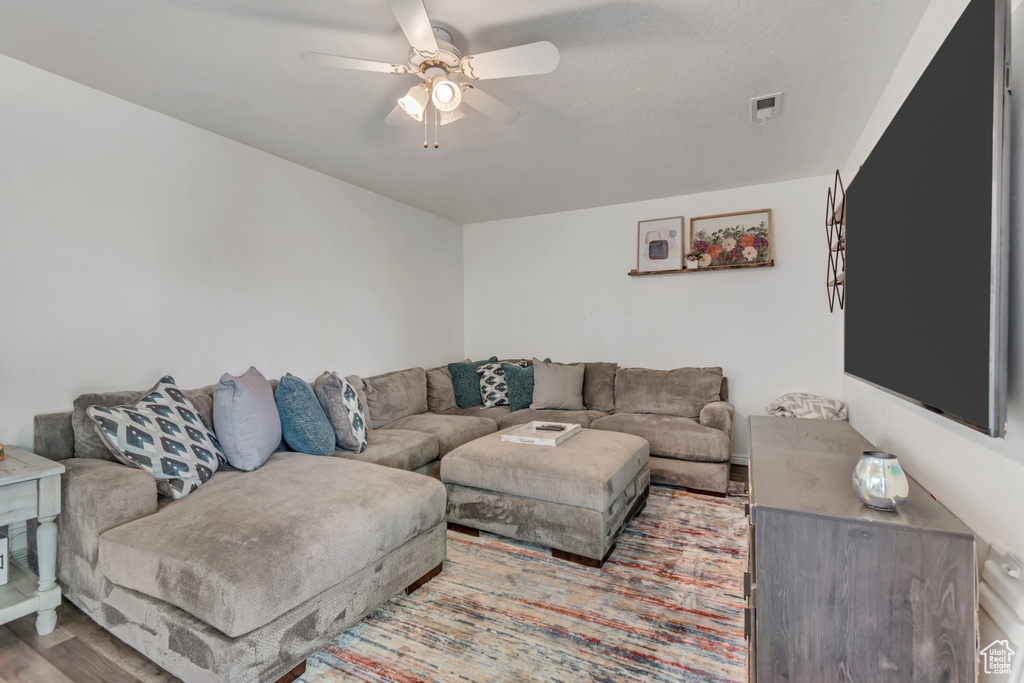 Living room featuring a ceiling fan and wood finished floors