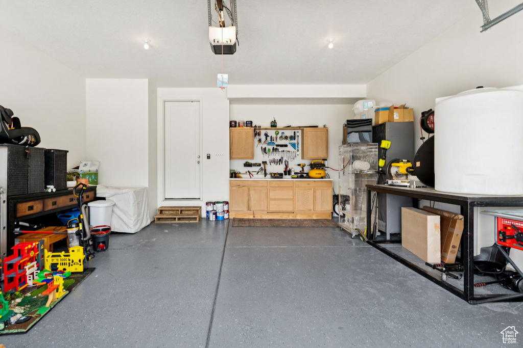Garage with a workshop area and a garage door opener