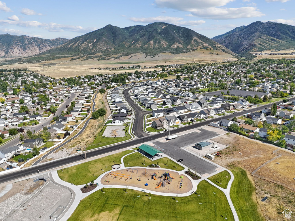 Aerial view of property's location with nearby suburban area and a mountainous background