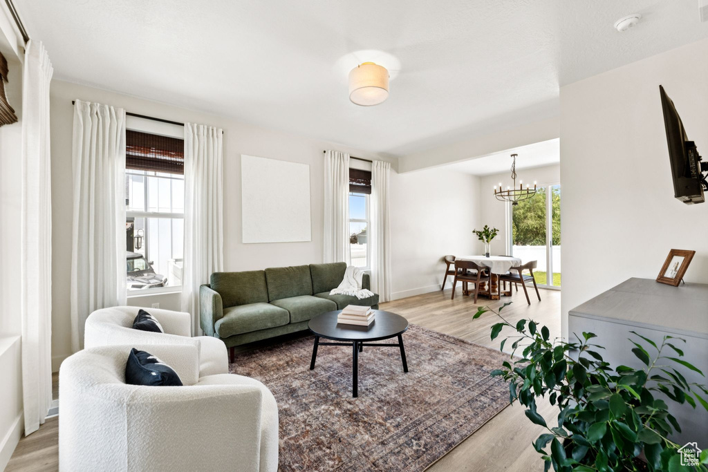 Living room featuring wood finished floors and a chandelier