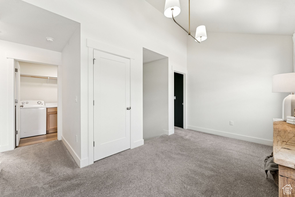 Unfurnished bedroom featuring washer / clothes dryer and carpet