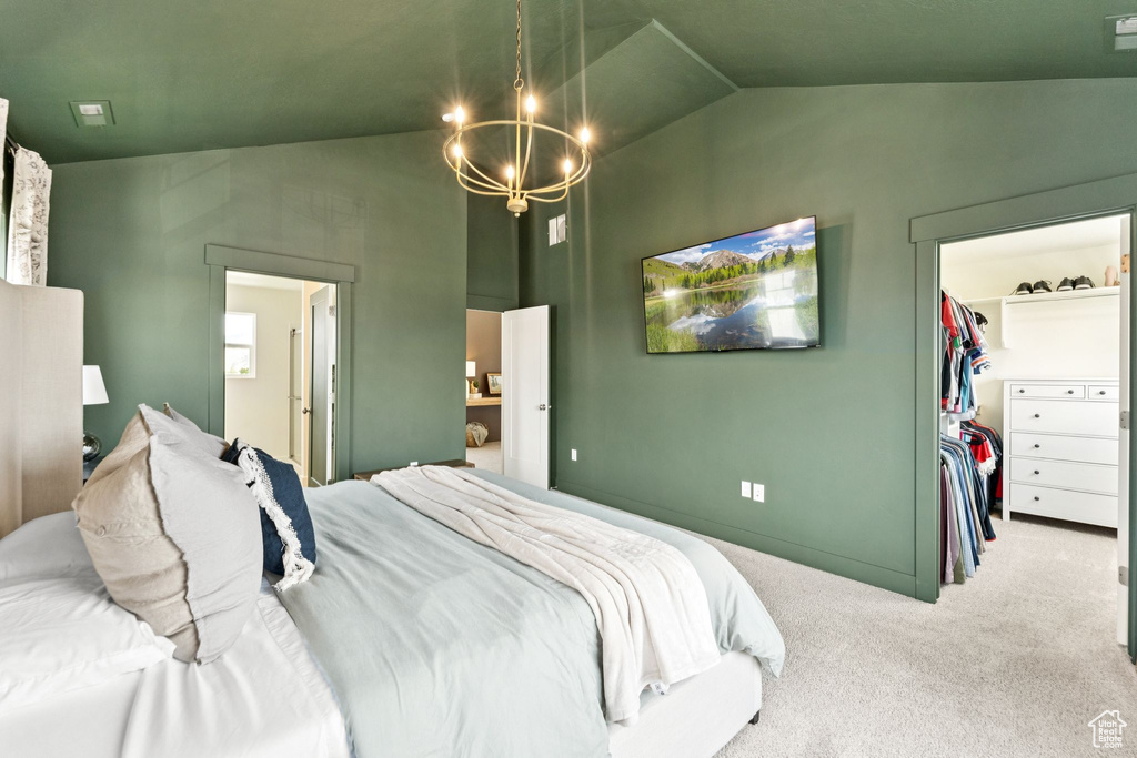 Bedroom with a chandelier, a walk in closet, carpet flooring, high vaulted ceiling, and a closet
