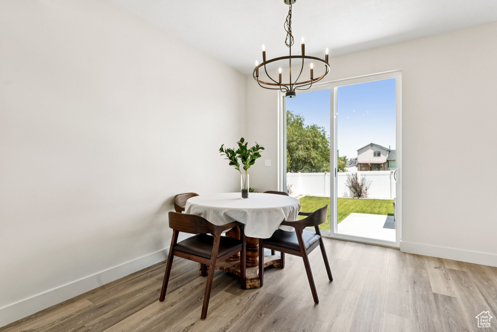 Dining space with a chandelier and light wood-style flooring