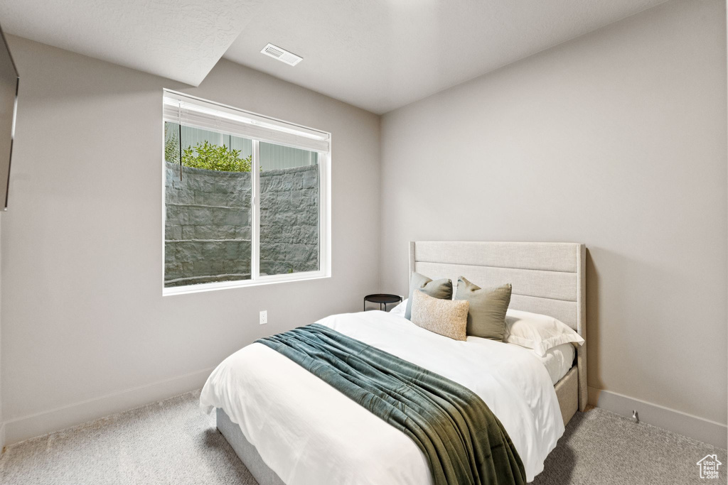 Carpeted bedroom featuring baseboards