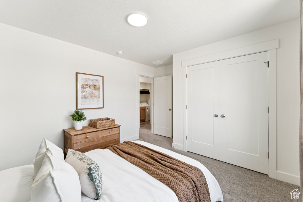 Carpeted bedroom featuring a closet and baseboards