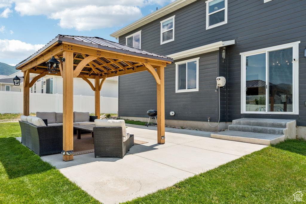 View of patio featuring an outdoor living space, entry steps, and a gazebo