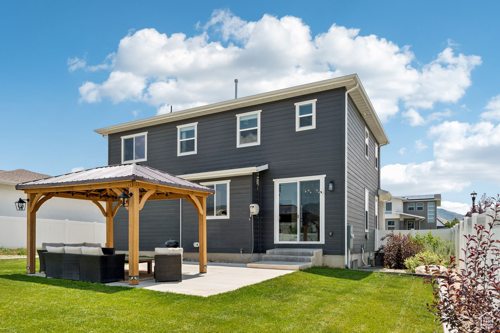 Back of property featuring an outdoor hangout area, a gazebo, entry steps, and a patio