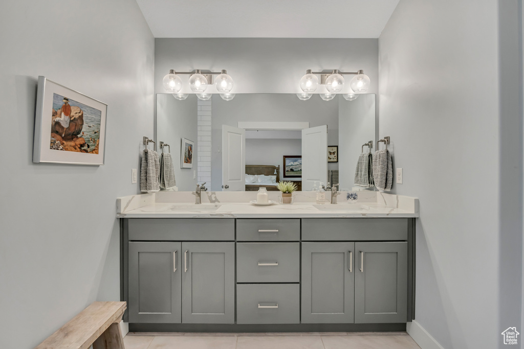 Bathroom featuring double vanity and tile patterned floors