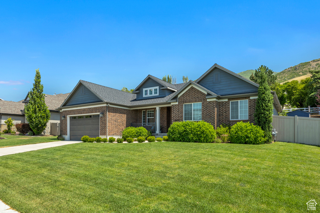 View of front of property featuring brick siding, a garage, and driveway