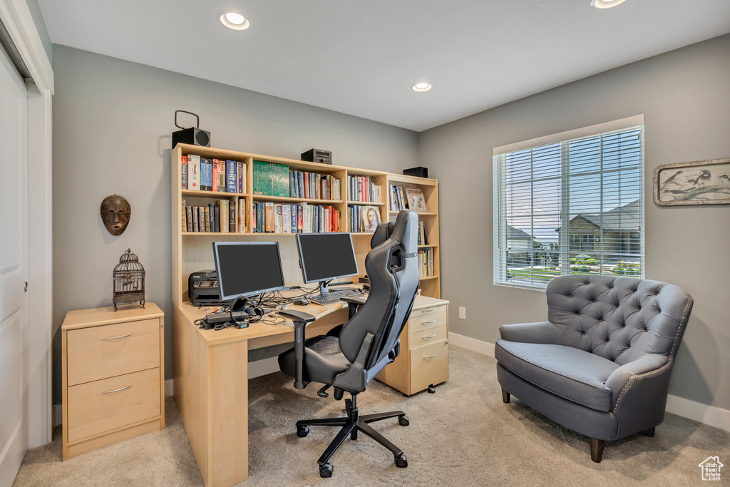 Office area with light colored carpet and recessed lighting
