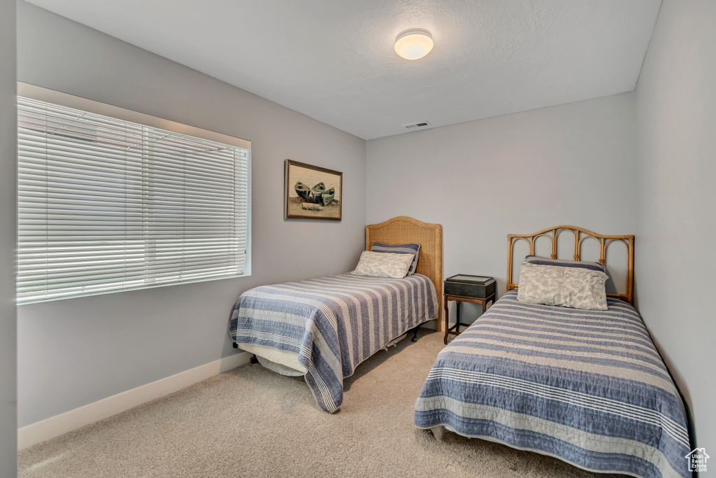 Carpeted bedroom featuring baseboards