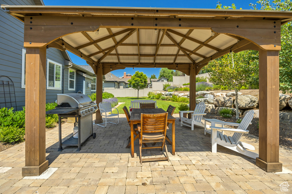 View of patio / terrace with a gazebo, area for grilling, and outdoor dining area