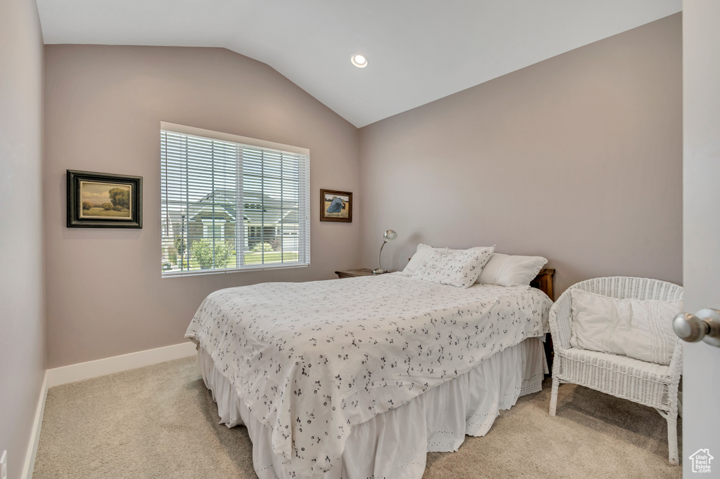 Bedroom featuring light carpet, lofted ceiling, and recessed lighting