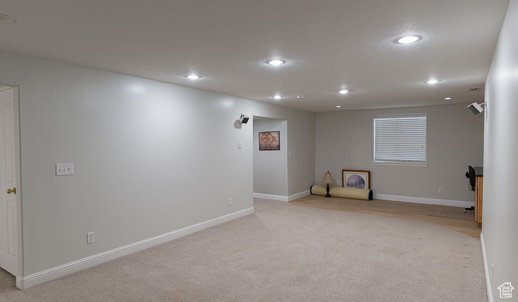 Below grade area with recessed lighting and light colored carpet
