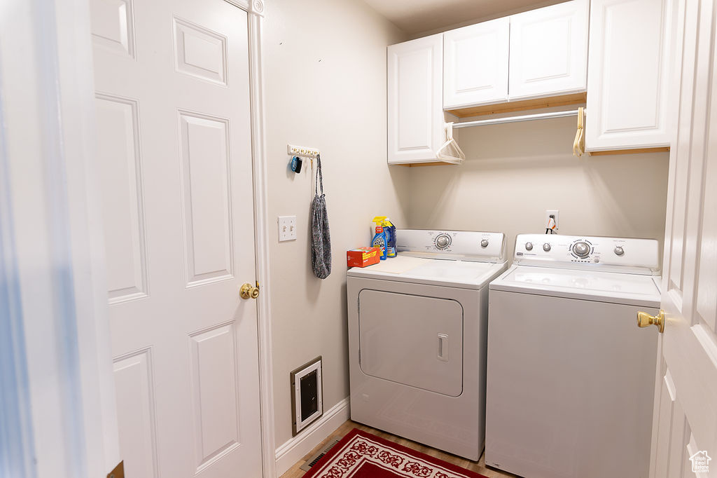 Laundry room featuring washing machine and dryer and cabinet space