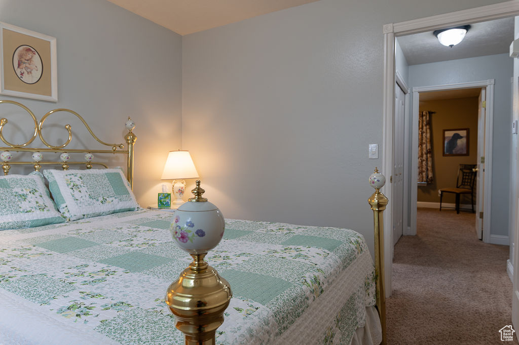 Bedroom with carpet flooring and baseboards