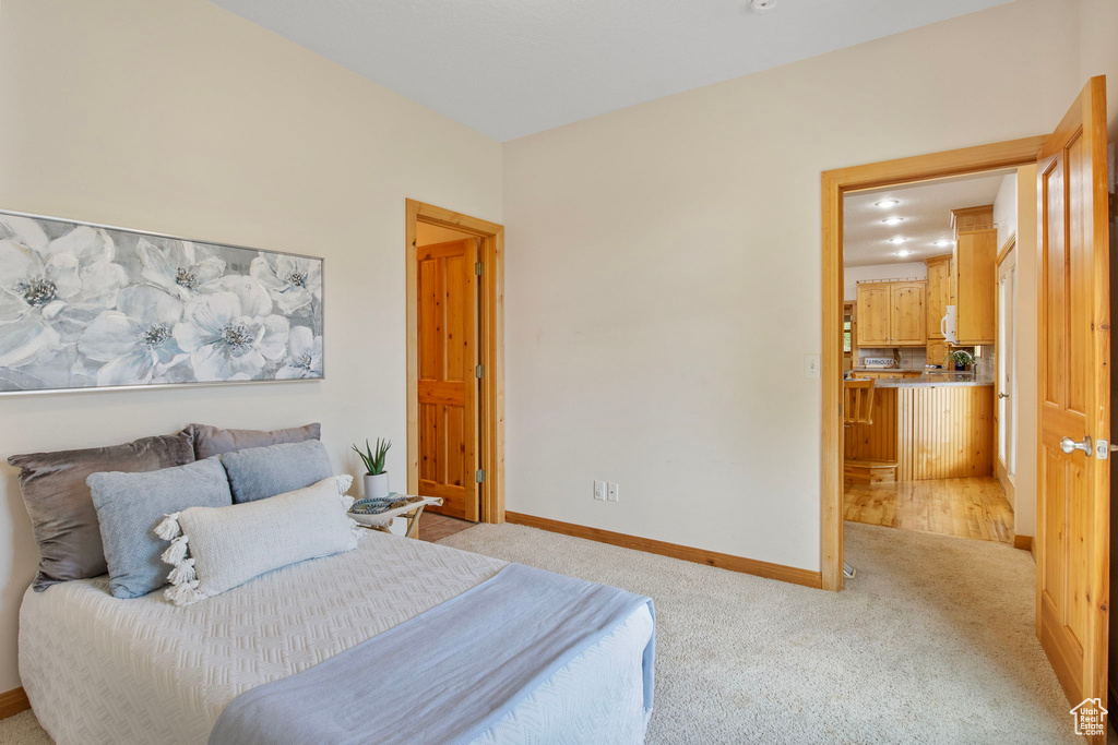 Bedroom featuring baseboards and light carpet