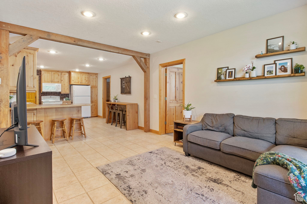Living room featuring recessed lighting and light tile patterned floors