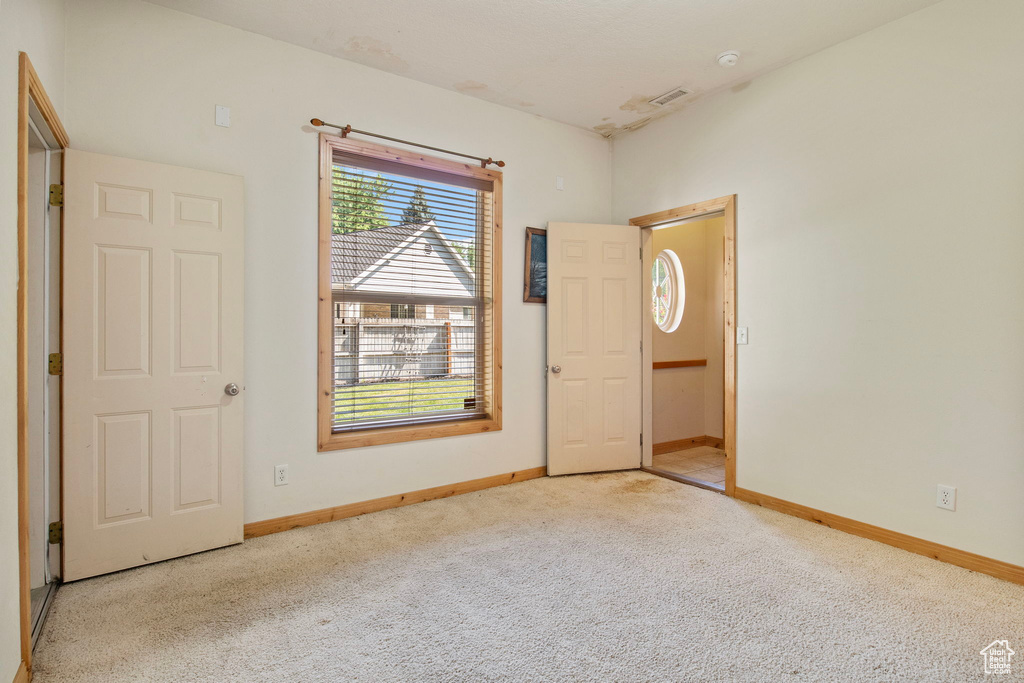 Carpeted spare room with baseboards