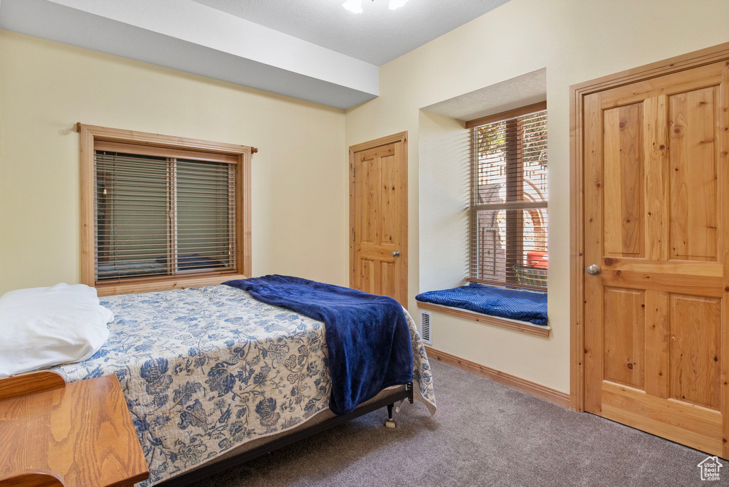 Carpeted bedroom featuring baseboards