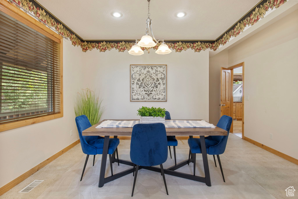 Dining area with a chandelier and recessed lighting