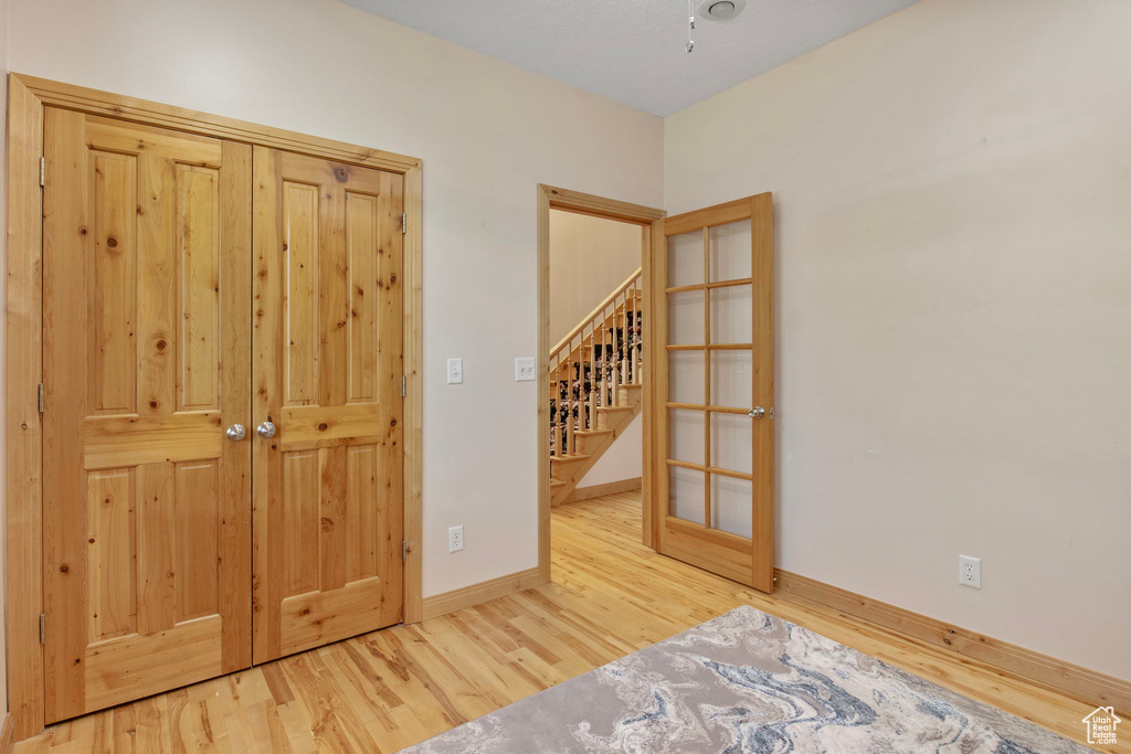 Spare room with wood finished floors and stairway