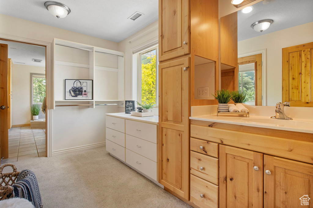 Full bath with vanity and baseboards