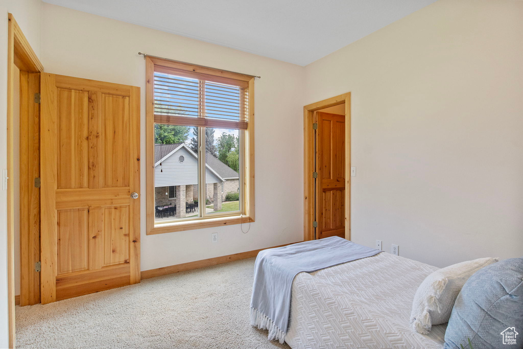 Bedroom with carpet floors and baseboards