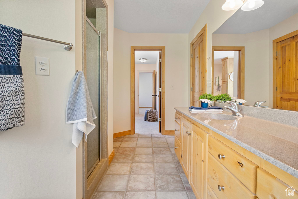 Full bath with vanity and a shower stall