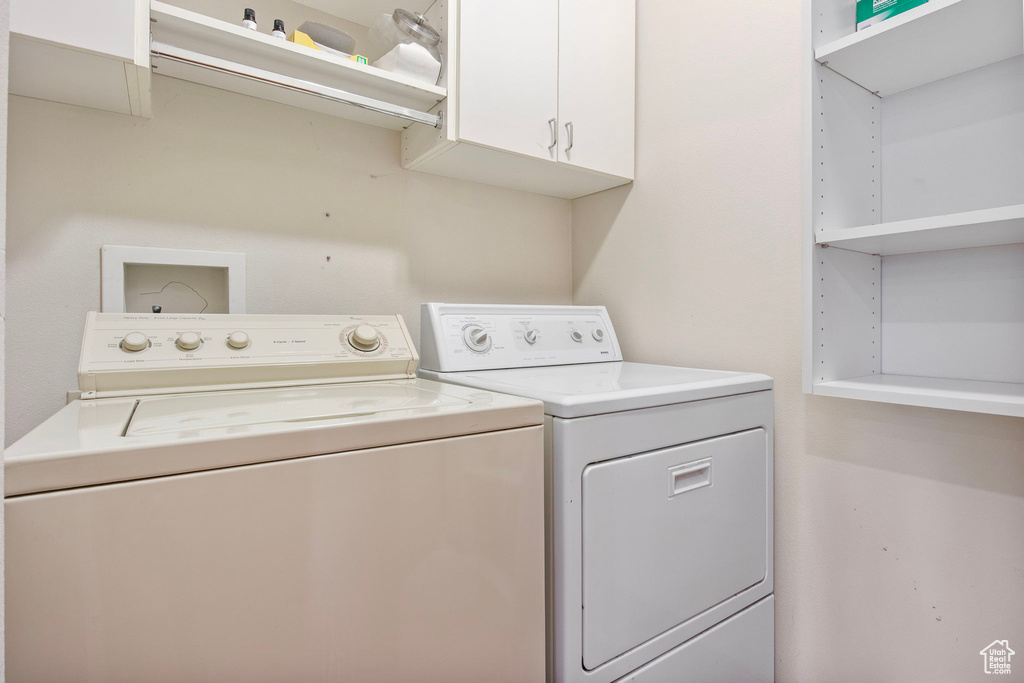 Laundry room featuring cabinet space and washer and dryer