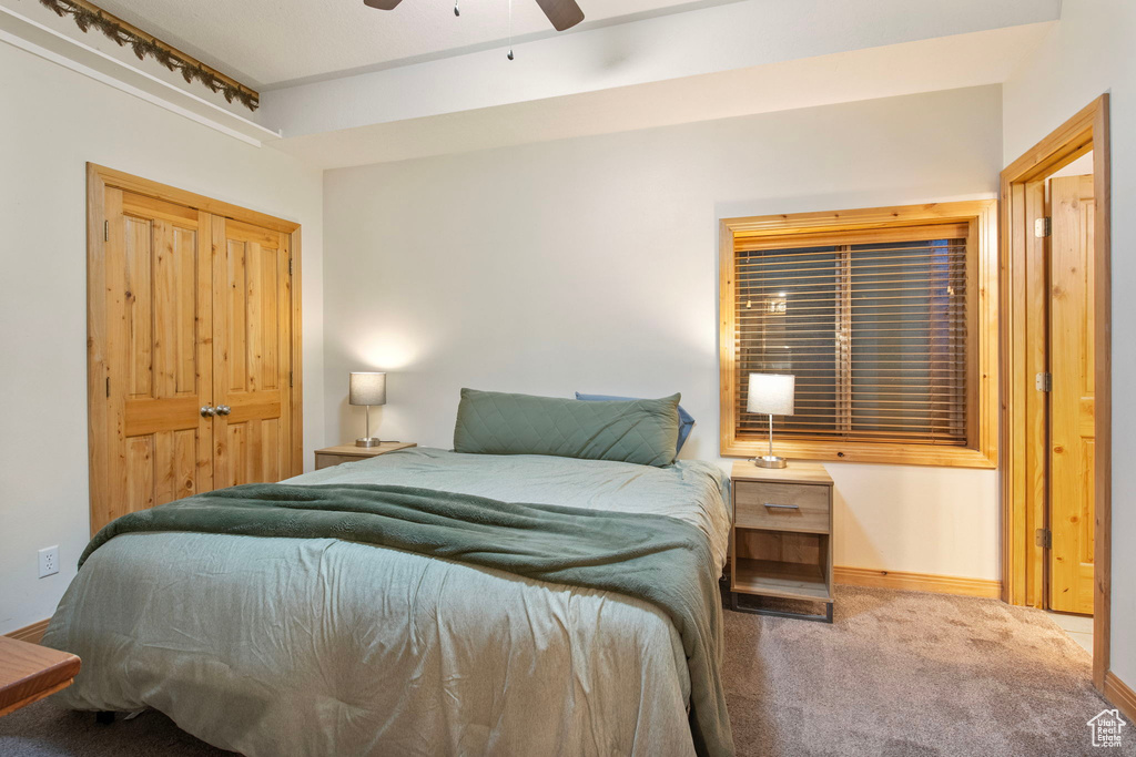 Bedroom with carpet floors, ceiling fan, and a closet