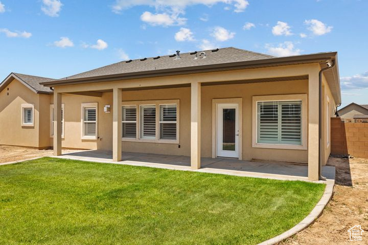 Back of property featuring a patio area and stucco siding