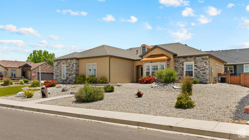 View of front of home featuring stone siding and stucco siding