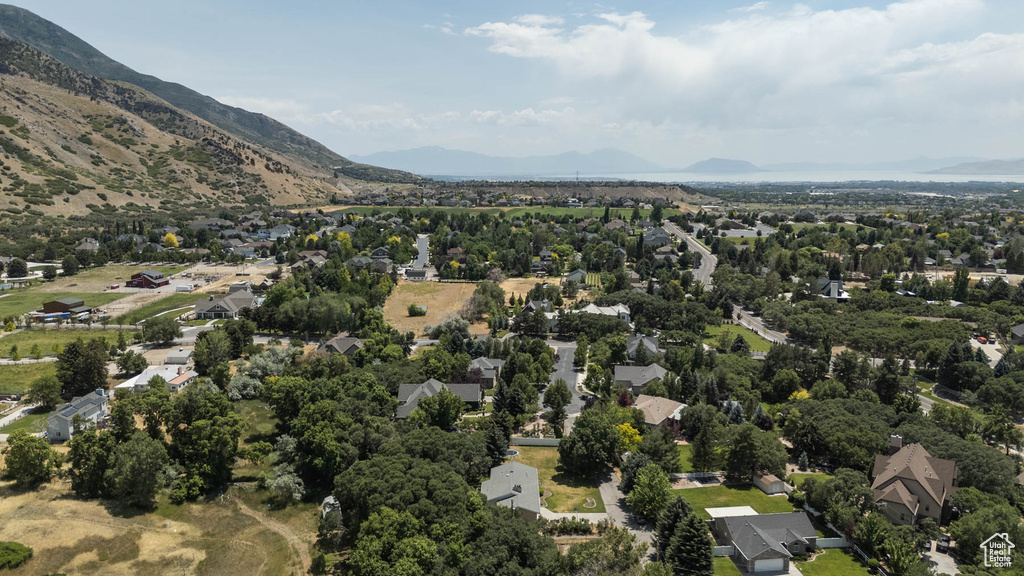 View of property location featuring mountains and nearby suburban area