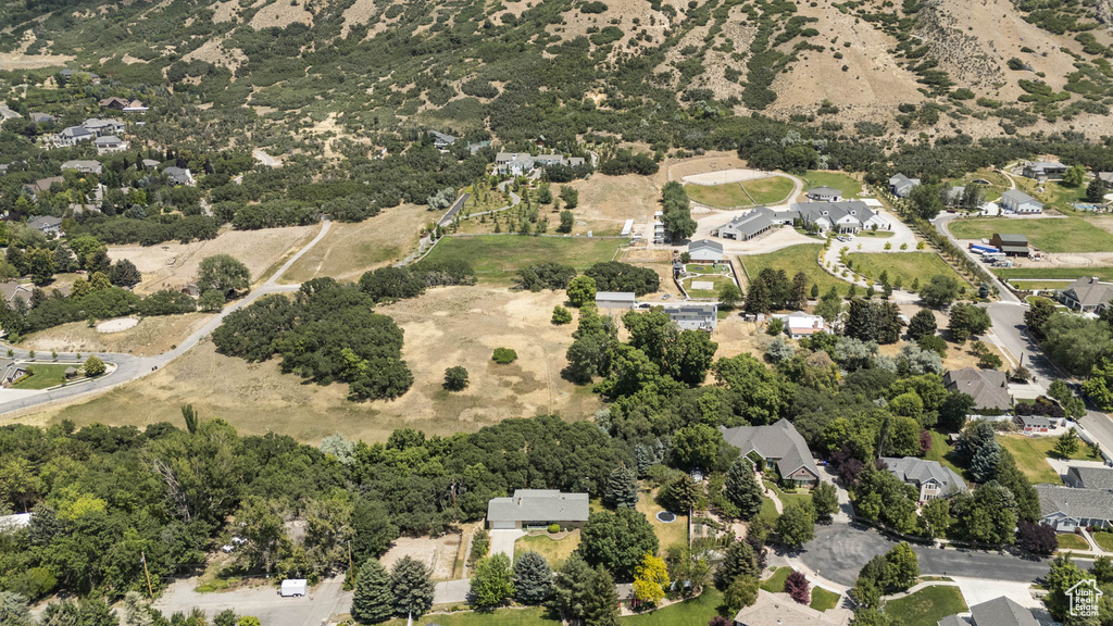 Aerial view of property and surrounding area with nearby suburban area